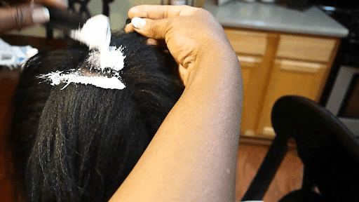 Apply hair relaxer gently from top to bottom