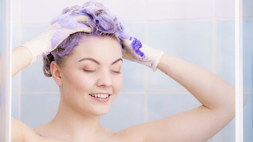 Using purple shampoo to neutralize brassy blonde hair